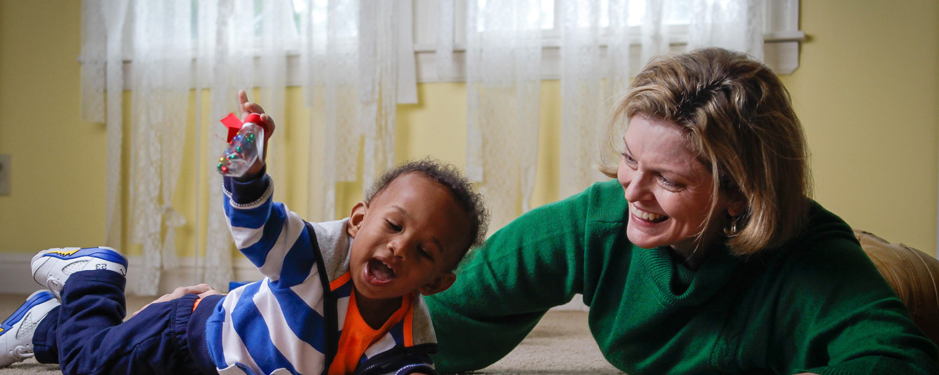 Anne Zachry, assistant professor of occupational therapy at UT Health Science Center and author of Retro Baby, plays with Gabriel (Gabe) Lewis, 1, son of Keisha Brooks (Martin ’98, HSC ’99), an assistant professor at UTHSC.