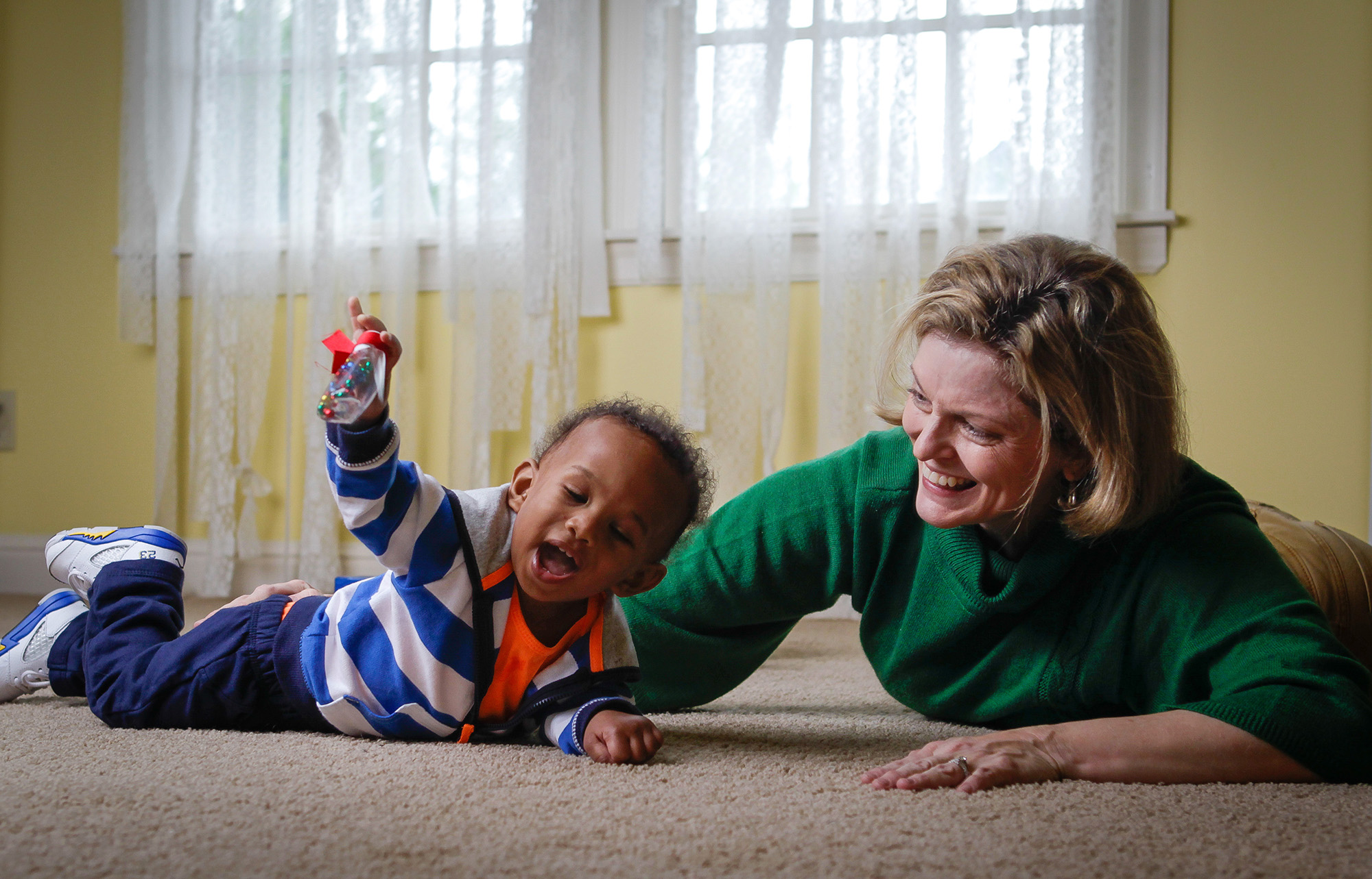 Anne Zachry, assistant professor of occupational therapy at UT Health Science Center and author of Retro Baby, plays with Gabriel (Gabe) Lewis, 1, son of Keisha Brooks (Martin ’98, HSC ’99), an assistant professor at UTHSC.