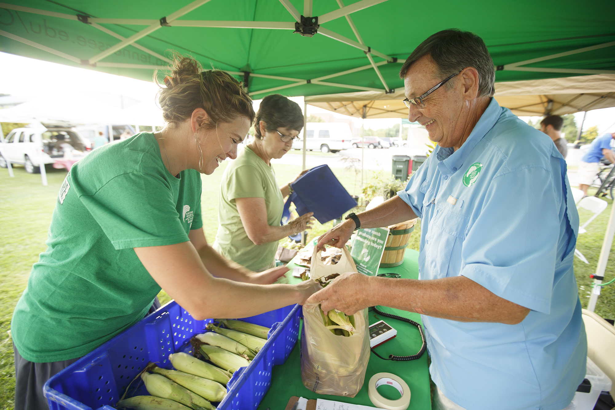 Whether it is a crate of corn or a handful of squash, no amount of fruits and vegetables is too small to fill the void of those who need it most. Jean Hulsey, left, assists Mike Smith, a volunteer of the Society of St. Andrew. Smith transports the produce to East Tennessee shelters and food banks.