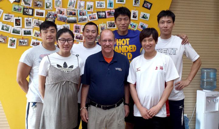 UT Martin Assistant Professor Dexter Davis, center, helps former Chinese athletes move on to the next phase after competition.