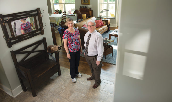Veronica Engle and Lawrence Schmitt stand in their home entrance