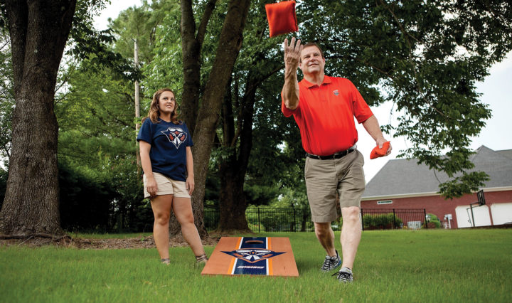 Scott Robbins and daughter Sydney play bag toss in yard