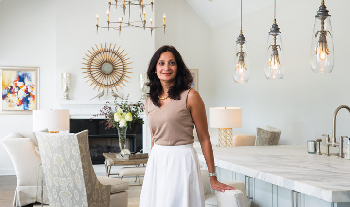 Monah Ahmad, interior designer stands in the family room for a condo project she designed