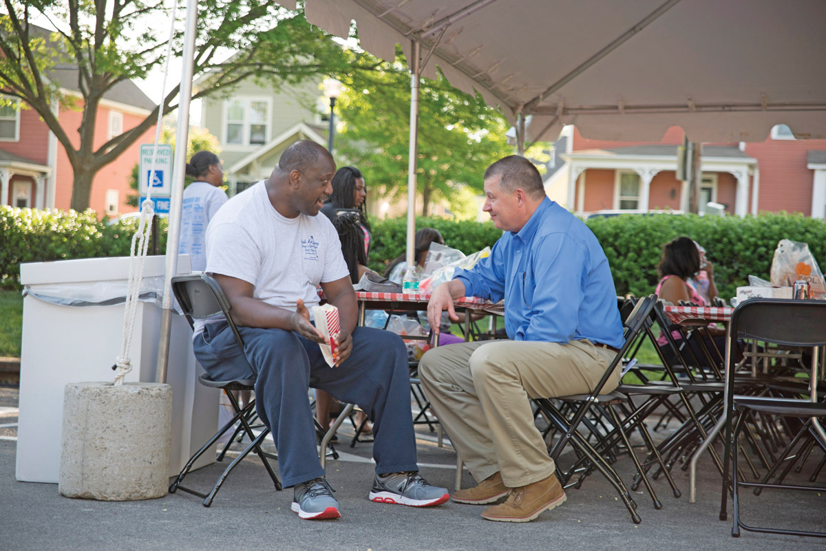 IPS Vice President Herb Byrd, right, visits with a neighbor at IPS block party.