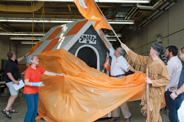 Tom Looney helps unveil Smokey’s Playhouse, raffled off to benefit Habitat for Humanity.