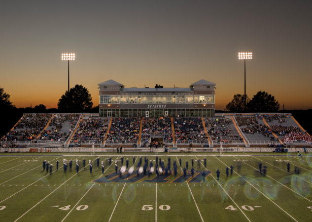 blurred motion photo of the marching band on the football field at dusk