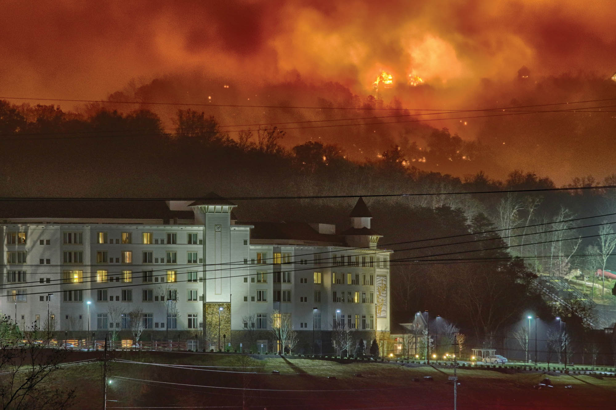 Fire can be seen on a ridge behind Dollywood’s Dreammore Resort in Pigeon Forge.