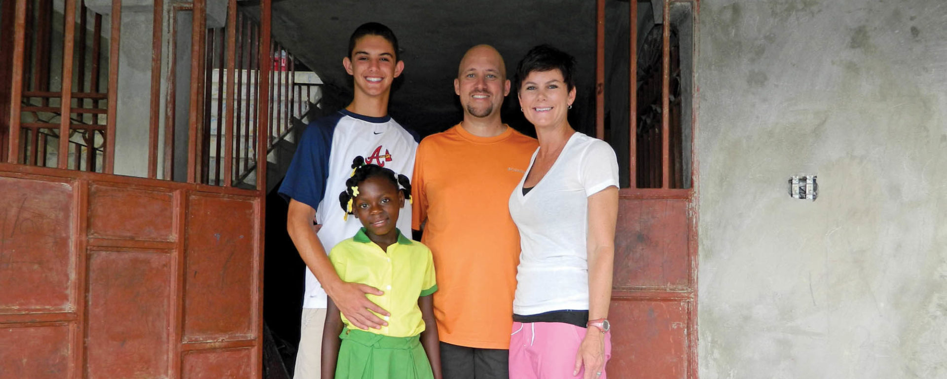 Harrison Kincaid, Onise, Stacy, and Sara Cox pose with one another in Haiti. (Photo courtesy of Stacy Cox)