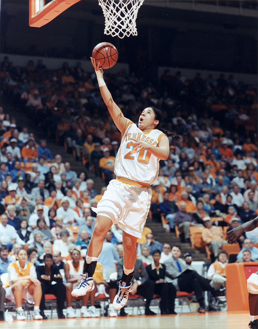 Kara Lawson in her Lady Vol uniform laying up a shot