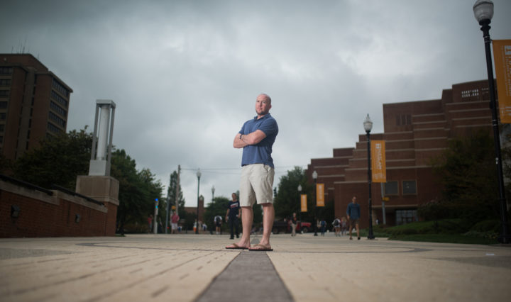 Jordan Harris stands in the center of the pedestrian walkway in front of Hodges Library in Knoxville