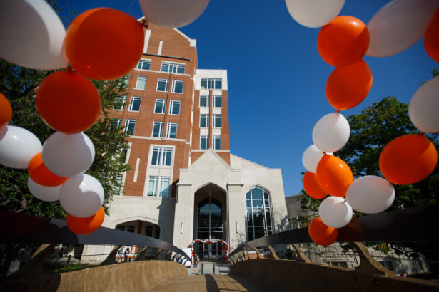 Strong Hall, framed by orange and white ribbons and balloons