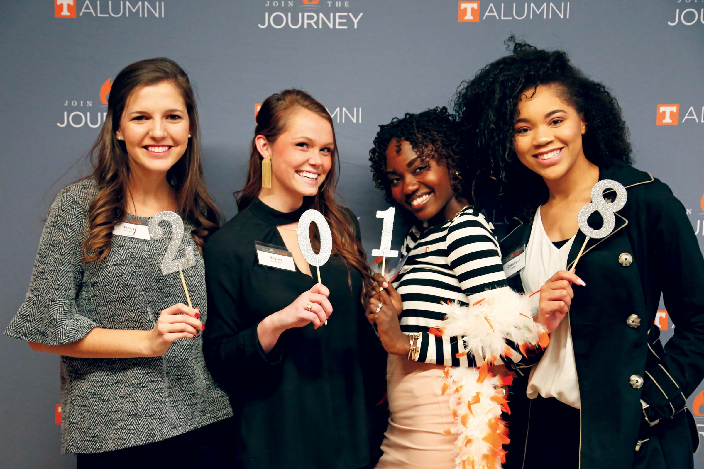 4 women from the UT Knoxville class of 2018 holding glitter-covered cardboard digits 2, 0, 1, and 8