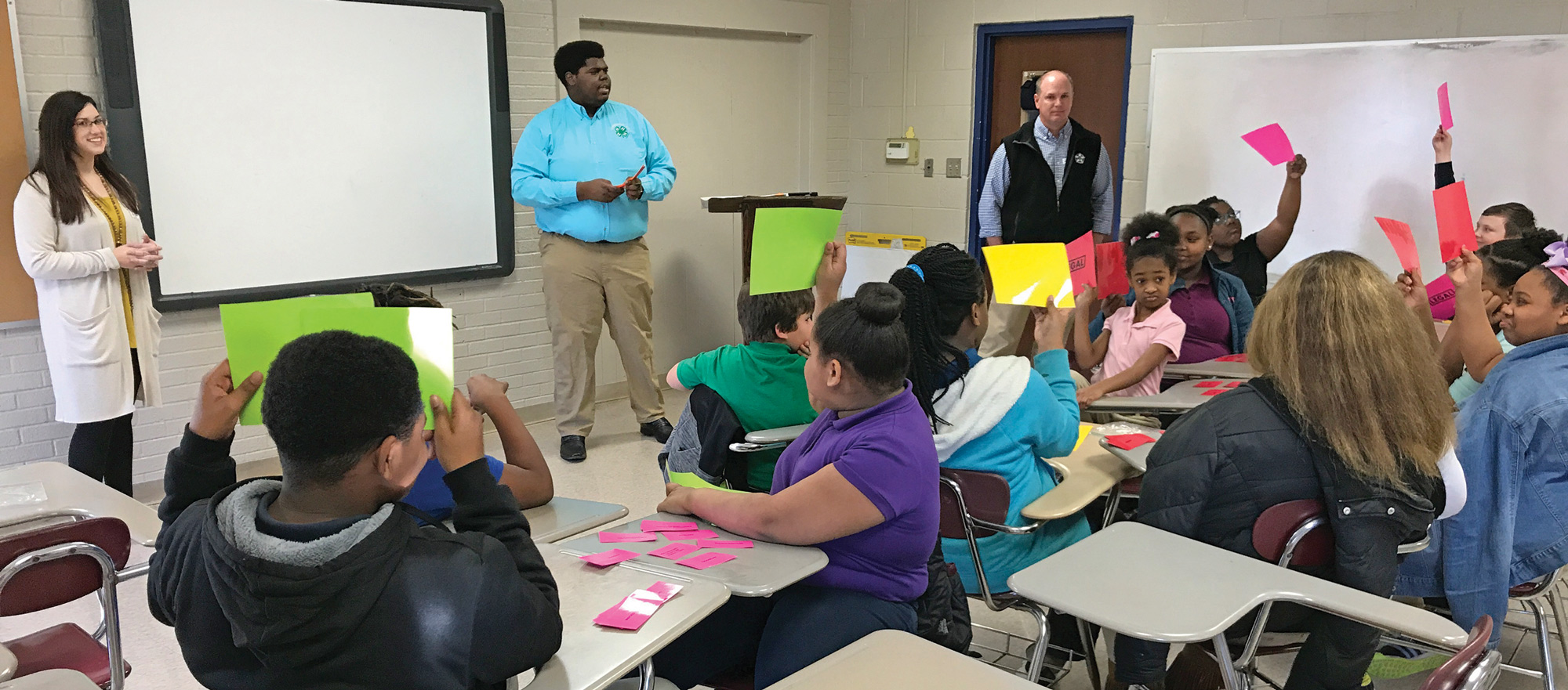 Left to right, UT Extension Agent Carrie Joyner, 4-H volunteer C.J. Bryson and Gibson County Sheriff Paul Thomas teach children about illegal and legal substances during Health Rocks. a 4-H program