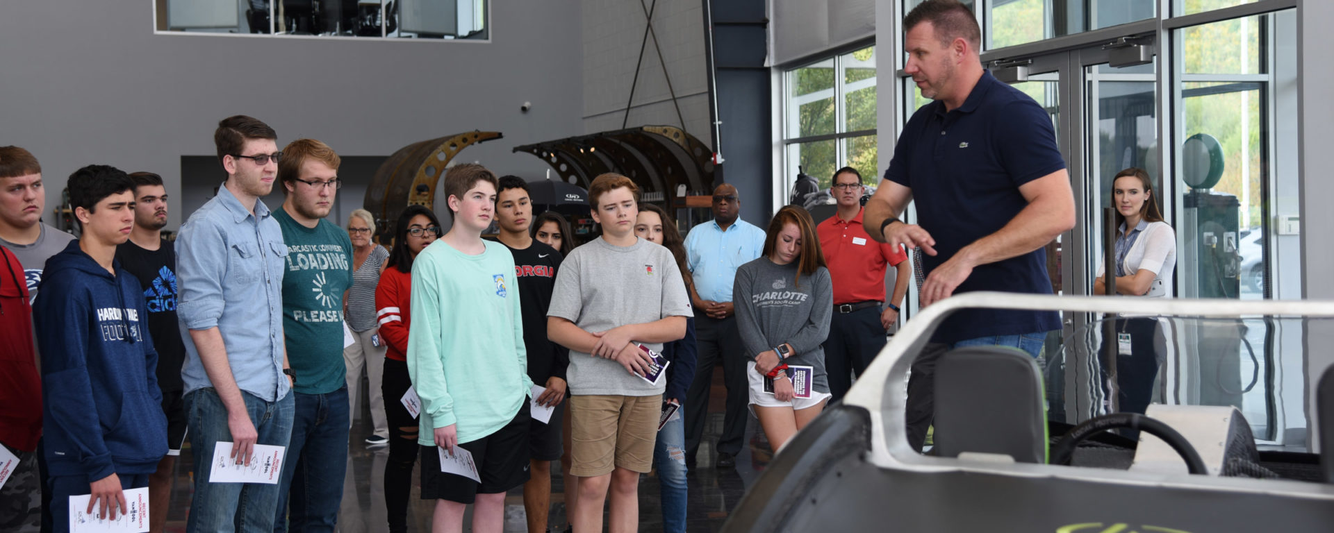 high school students touring an automobile manufacturing facility