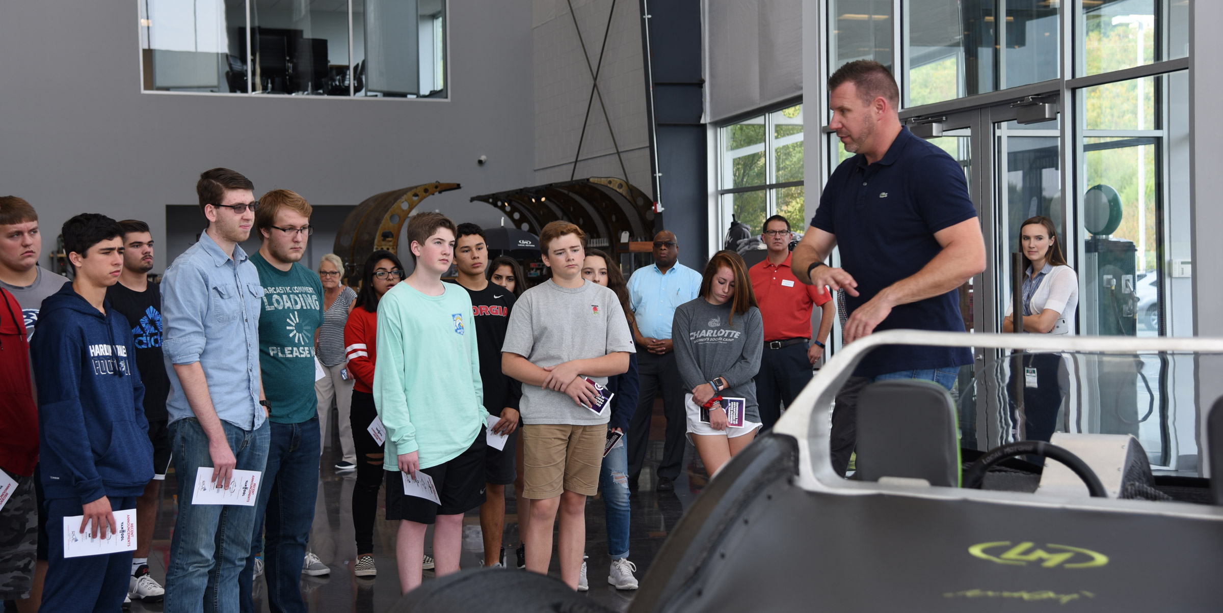 high school students touring an automobile manufacturing facility