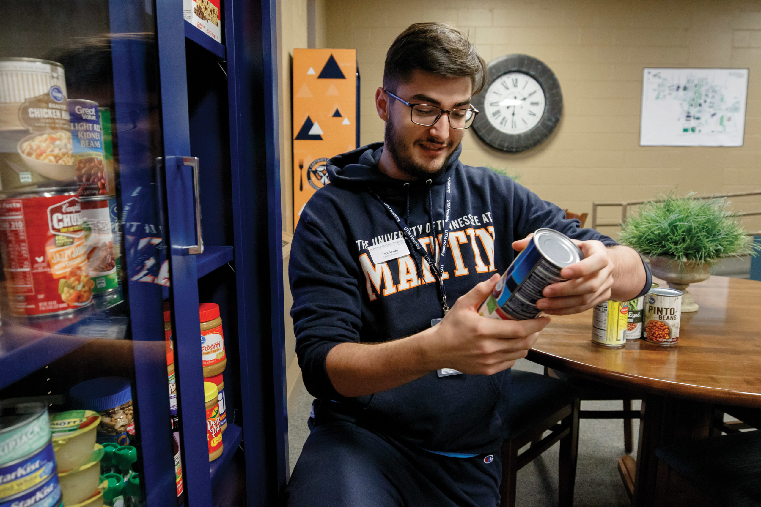 A UT Martin student volunteer sorts canned goods in the food pantry