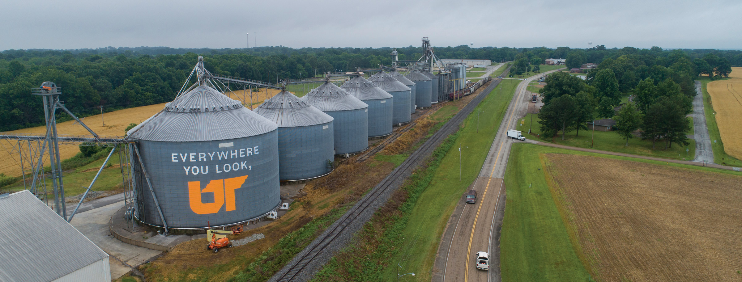 A row of grain silos in Sharon, TN. The largest and frontmost silo is painted with "Everywhere You Look, UT"