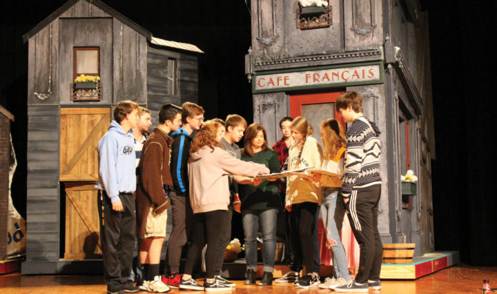 Theater teacher Alison Manning and her students on set