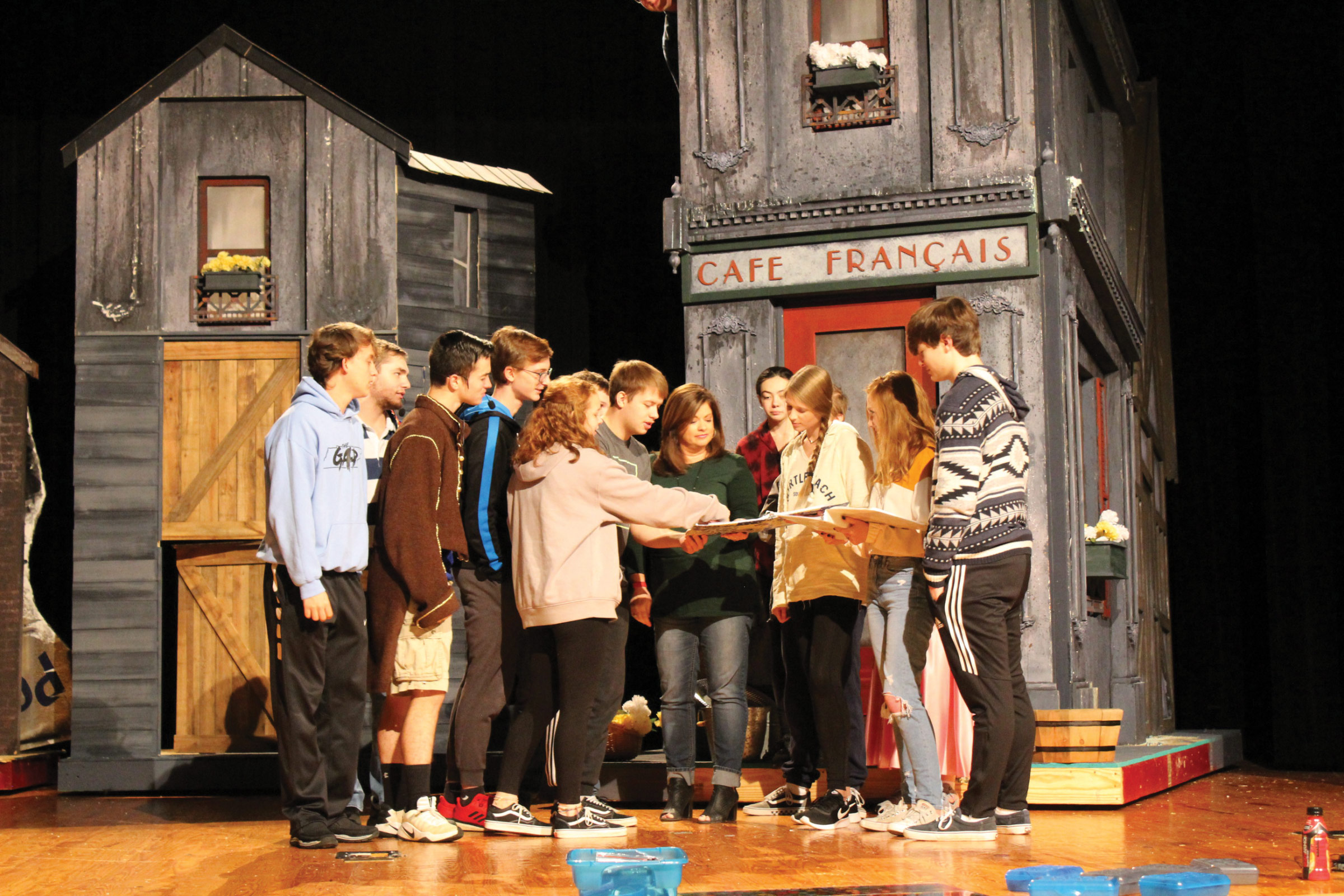 Theater teacher Alison Manning and her students on set