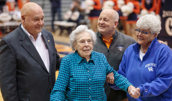 Keith Carver and Athletic officials guide Bettye Giles to center court to present her with an award.
