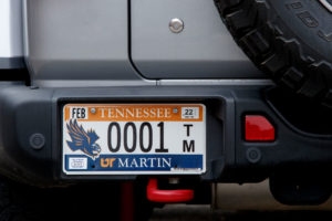 The new U T M licensplate on a rear bumper with number 0001