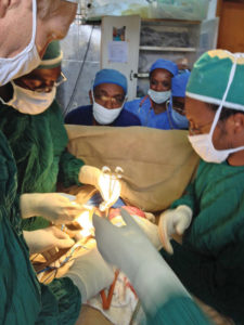 surgeons and assistants participate in a procedure