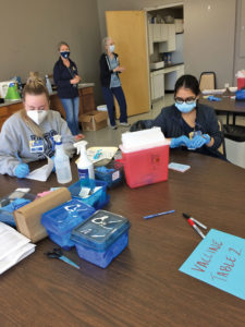 Nursing volunteers in sterile gloves and face masks at Dogwood manor