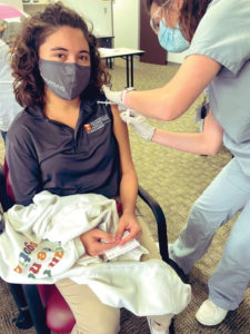 A UTK nursing student gets a vaccine from her classmate