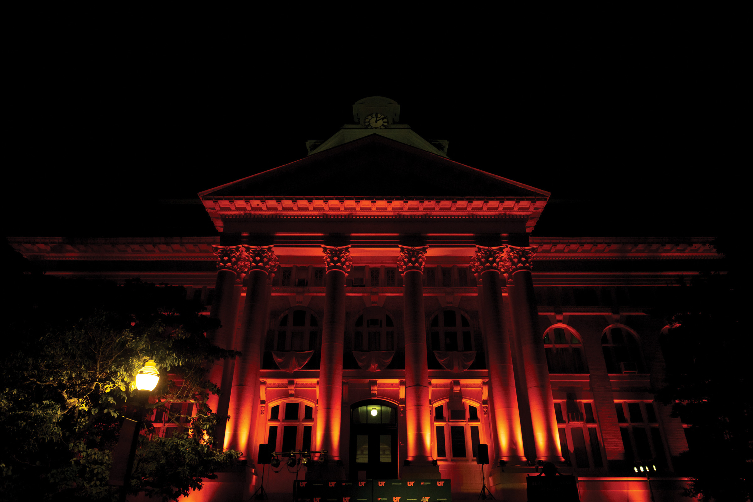 A darkened courthouse illuminated with red and orange lights