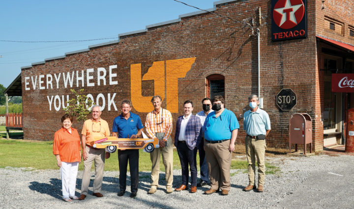 Randy Boyd and a group of locals in Fruitvale, Tennessee in front of the Everywhere You Look mural