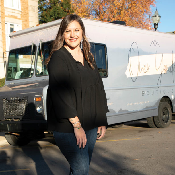 Asheton stands in front of her business' truck, painted with the name Over Yonder Boutique