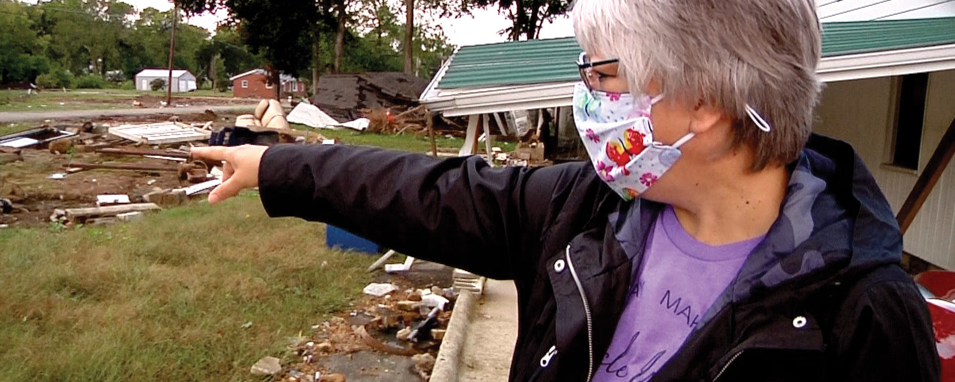 Debra Ashton surveys flood damage near her home in Waverly