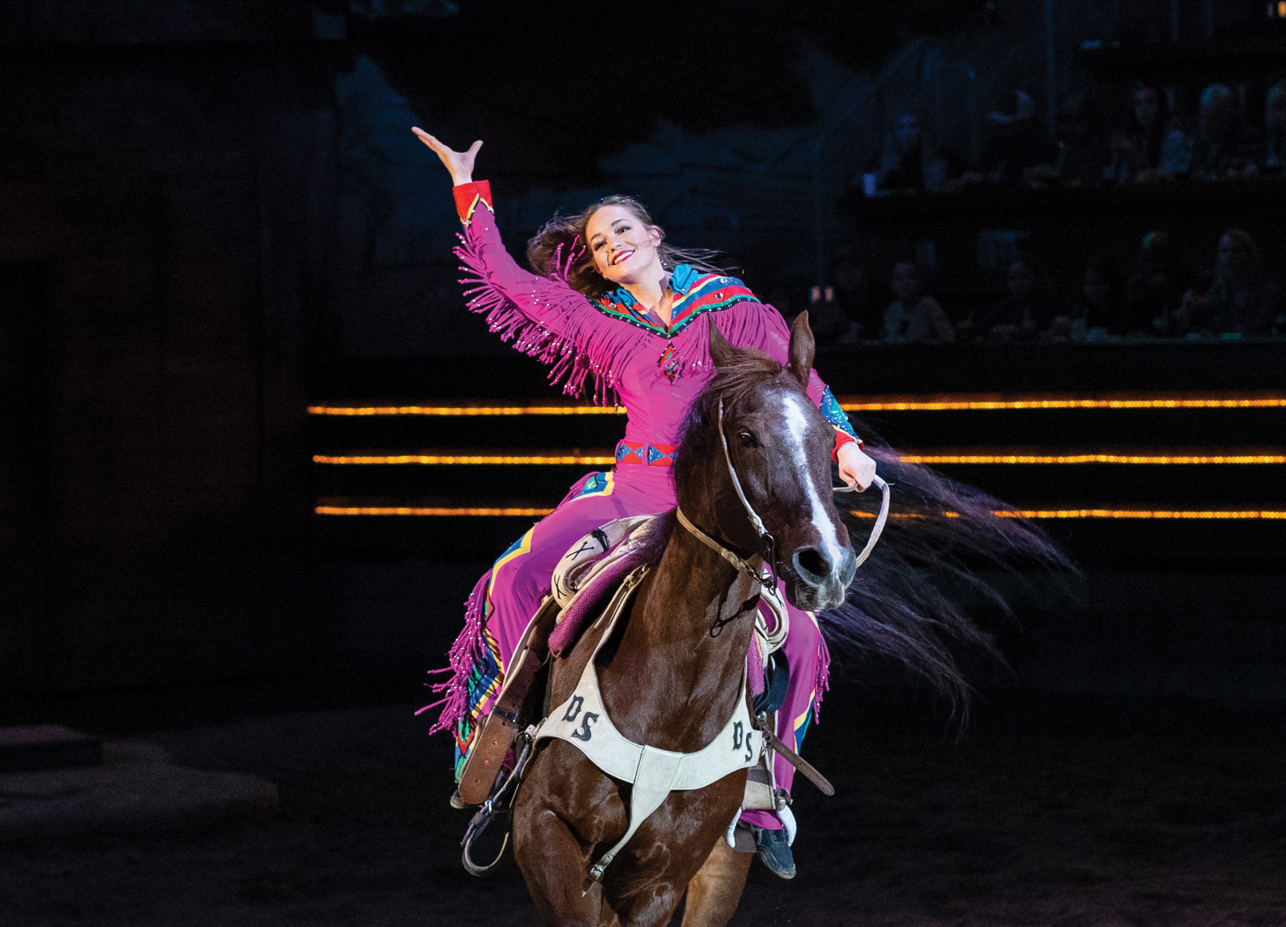 Emma Jo Eversole greets the crowd on horseback at Dolly Parton's Stampede