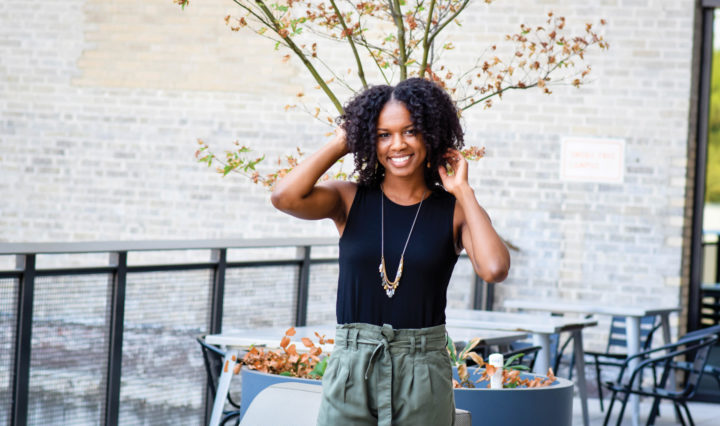 Samaria Grandberry stands in an outdoor cafe
