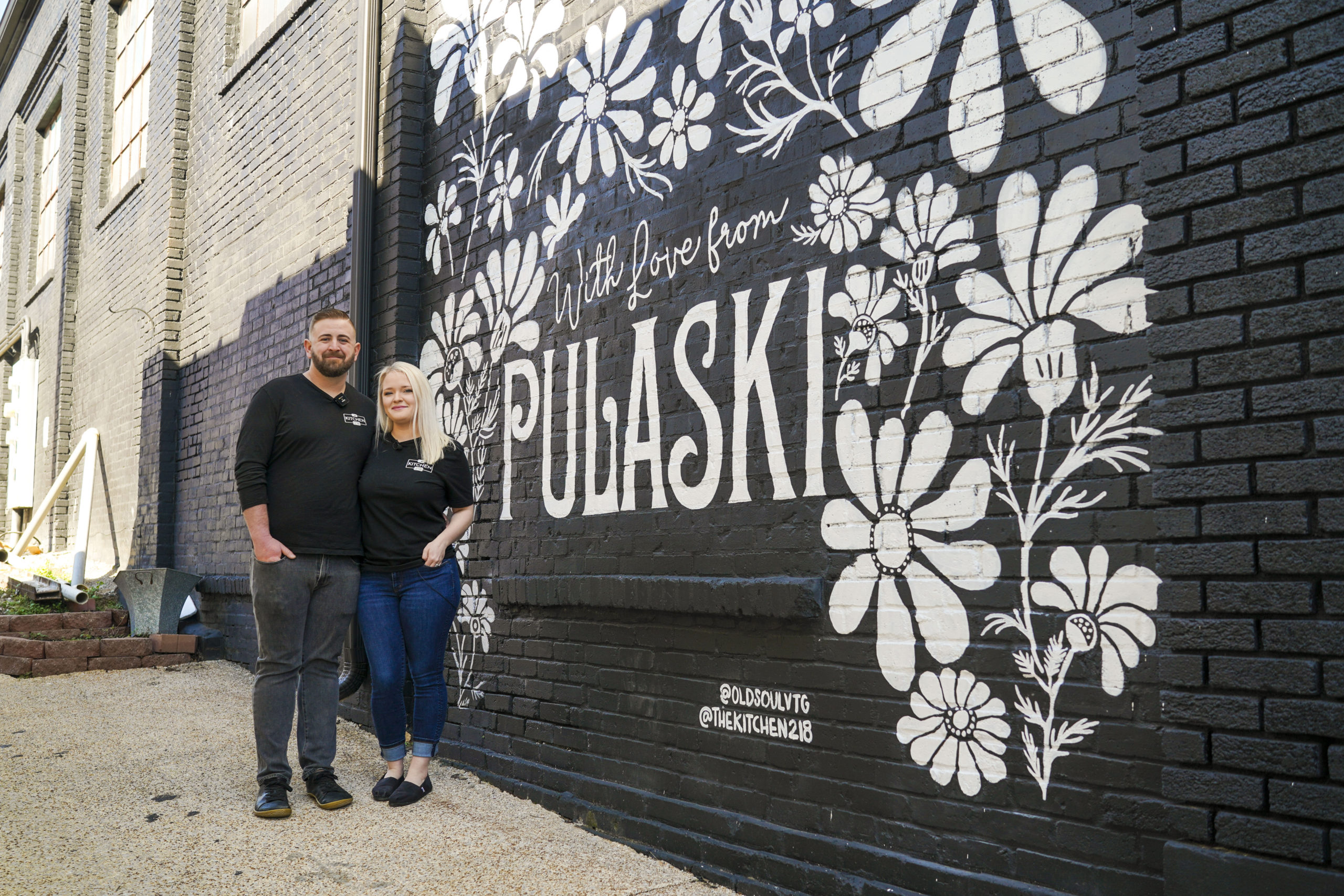 Kitchen 218 owners Jake and Michelle Pfeiffer pose outside their new restaurant in downtown Pulaski.