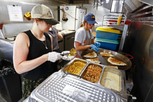 UT Knoxville students prepare orders on the food truck.
