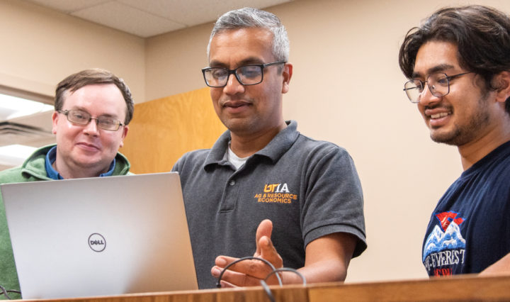 Sreedhar Upendram (middle) demonstrates using a hot spot for broadband to James Mingie, a research associate, left, and graduate student Amrit Shrestha.