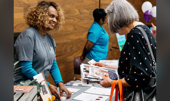Gloria Thomas Anderson, left, founder of Heart Tones, offers information to attendees at the engAGING Communities Open House workshop in Nashville.