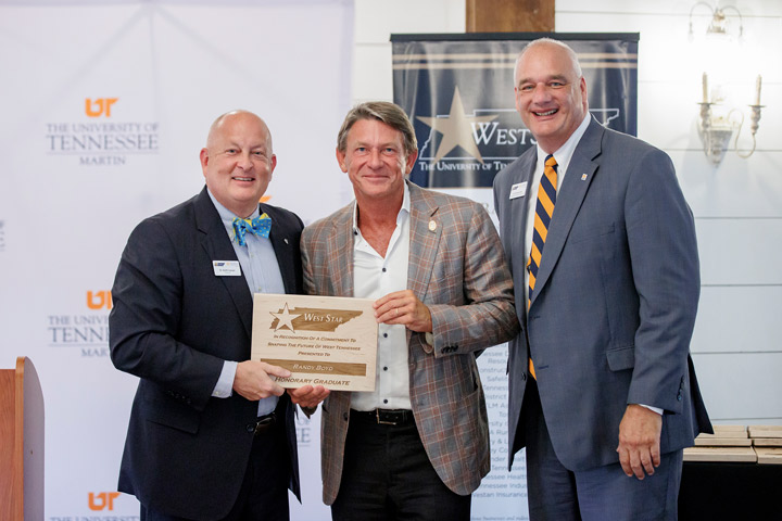 Presenting UT President Randy Boyd with a WestStar plaque are, left, Keith Carver, UT Martin chancellor, and, right, Charley Deal, WestStar secretary of the board and UT Martin vice chancellor for university advancement. 