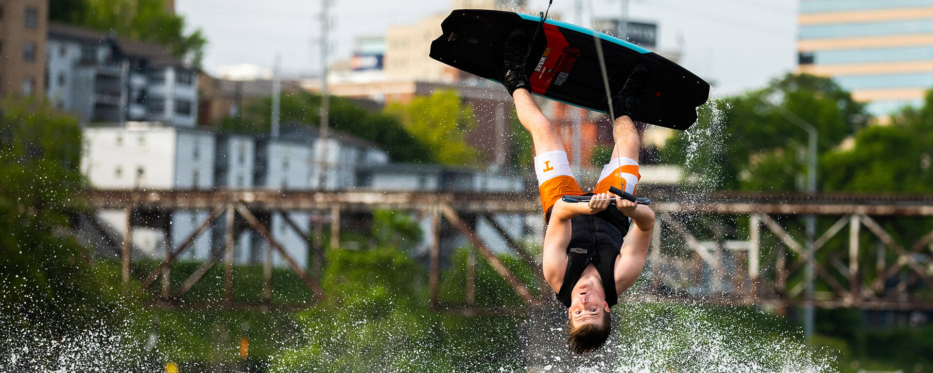 A UT Knoxville Volwake member turns a flip on his wakeboard during practice on the Tennessee River. Photo by Steven Bridges, University of Tennessee, Knoxville
