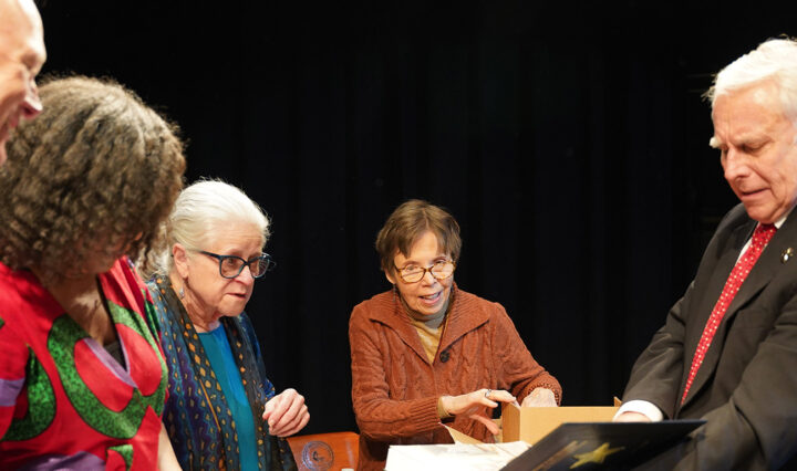 From left, Lester Laminack, Kelly Starling Lyons, Carol Hampton Rasco, George Ella Lyon and Ronnie Erwin review books during the children’s literature conference.