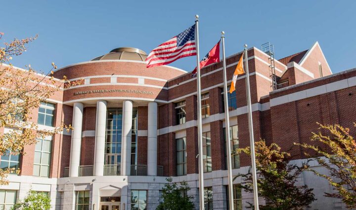 Entrance of the Howard H. Baker Jr. Center for Public Policy building with flags waving in the wind.