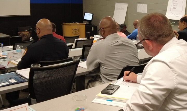 Attendees take notes during a classroom lecture at the Memphis Police Department Leadership Academy.