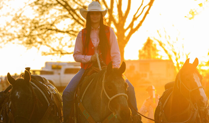 Grace Bryant riding her horse and guiding two others in preparation for the 55th Annual UTM Spring College Rodeo.