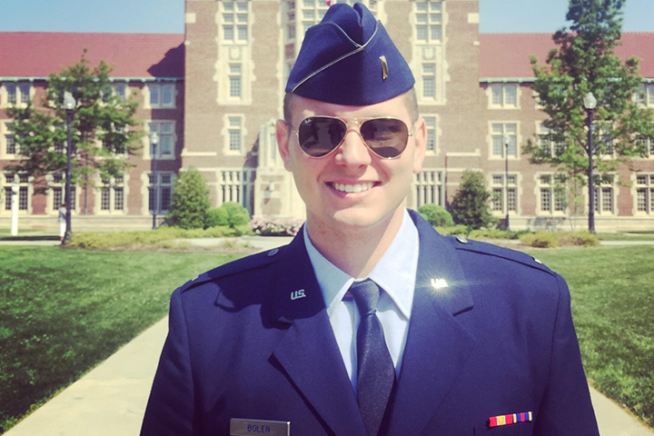 Aaron Boles standing in front of Ayers Hall at UTK in his military uniform.