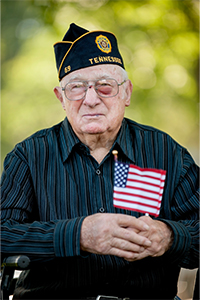 T Joe Walker holding a miniature American Flag.