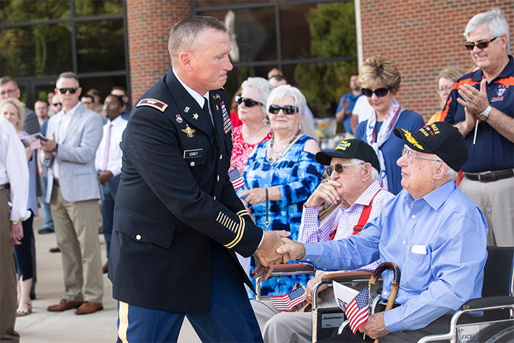 T Joe Walker shakes hands with a U.S. Army officer during a Memorial Day service at UT Martin.