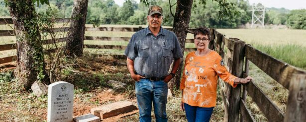 UTIA Farm Manager Brandon Beavers and Pat Hitson Reilly stand by the grave of Reilly's relative and Revolutionary War veteran James Trice.