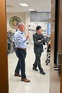 Ahad Nasab, interim dean of the College of Engineering and Computer Science, shows Cap Nguyen the mechatronics laboratory.
