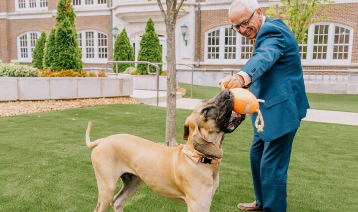 UTHSC Chancellor Peter Buckley plays with his dog, Finn Mac Cool, on the campus' quad.